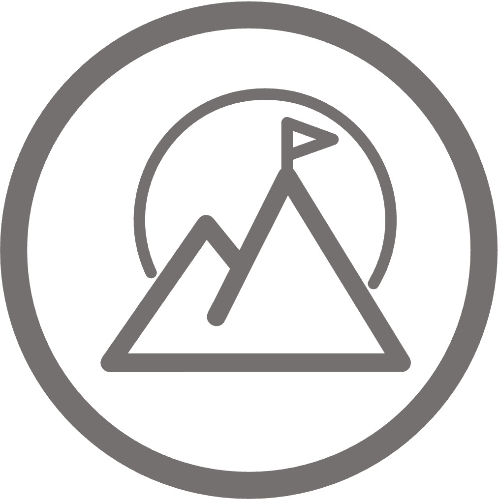 Circular icon of flag-topped mountain mountain