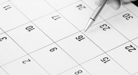 Pen pointing at calendar