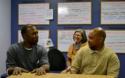 Two men and a woman sit together