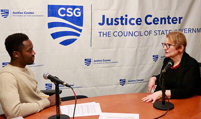 Rashawn Davis sits at a table with Esta Bigler