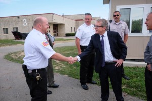 Photo of Gov. DeWine shaking hand s with corrections workers