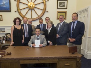 Nevada Governor Brian Sandoval and the Juvenile Justice Improvement Initiative Task Force, celebrate after he signs the Juvenile Justice System Reform Act into law.